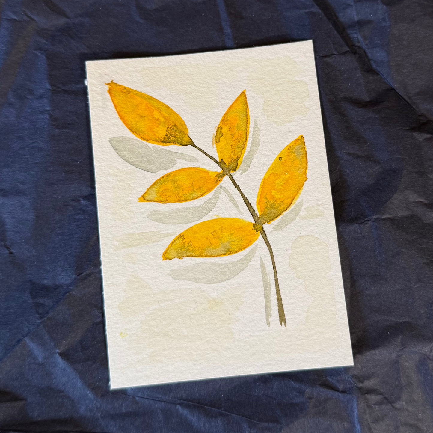 2.5 x 3.5in watercolour piece of a yellow fall leaf with five segments.